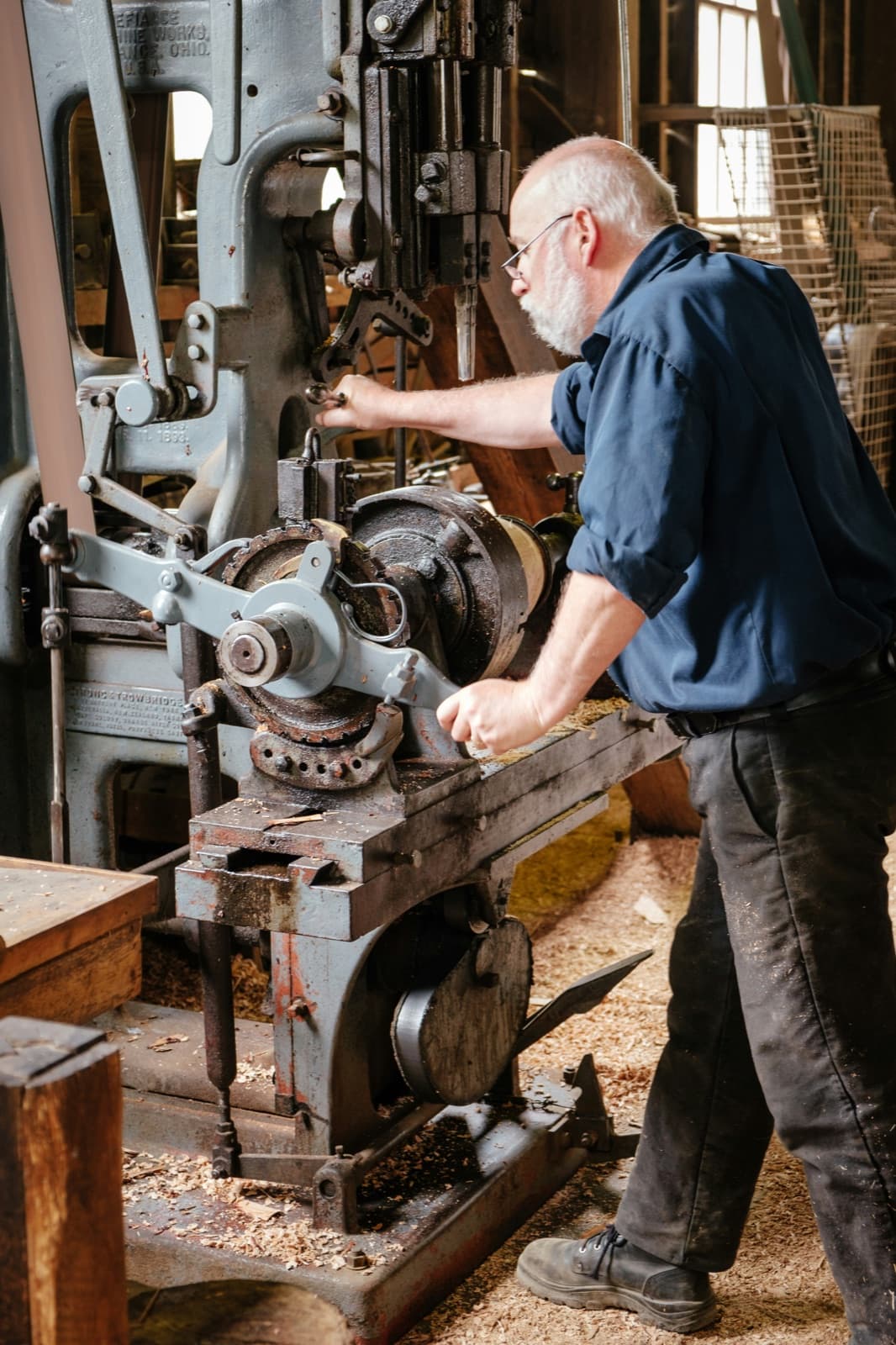 Craftsman working timber in a traditional workshop